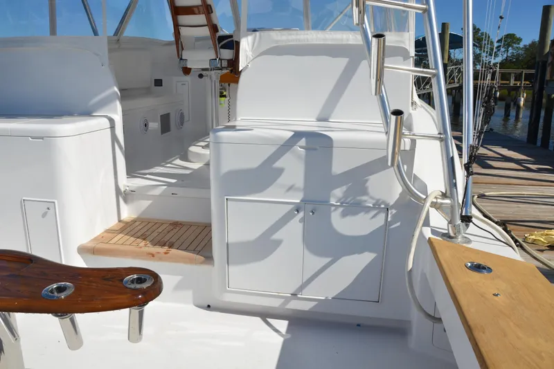 Slide: The Image of 2006 Custom Carolina Heritage Express boat interior with white seating and wooden accents. - 8