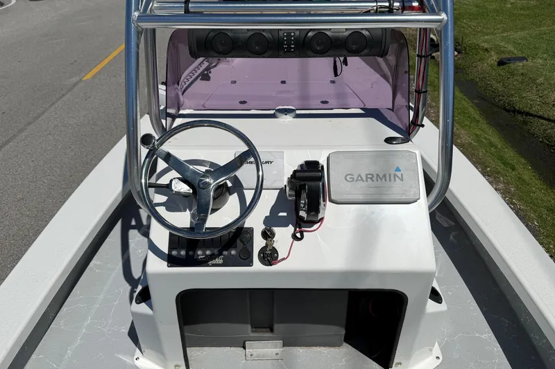 Slide: The Image of 2022 Majek 18 M2 boat console with steering wheel and Garmin navigation system. - 10