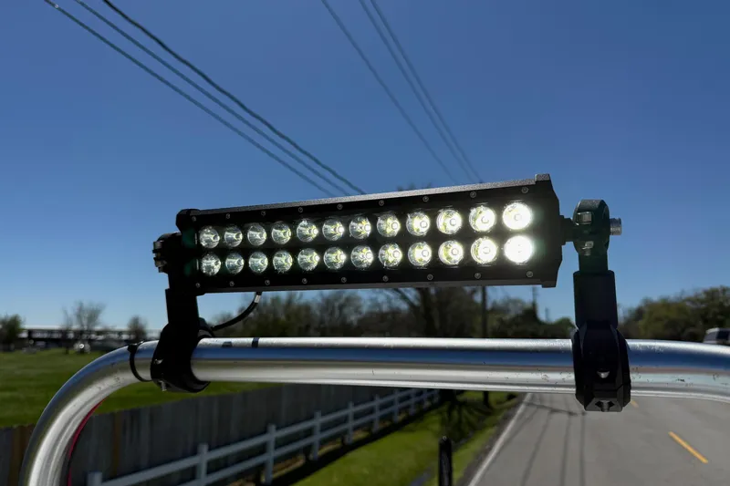 Slide: The Image of LED light bar mounted on a 2022 Majek 18 M2 boat under clear blue sky. - 18