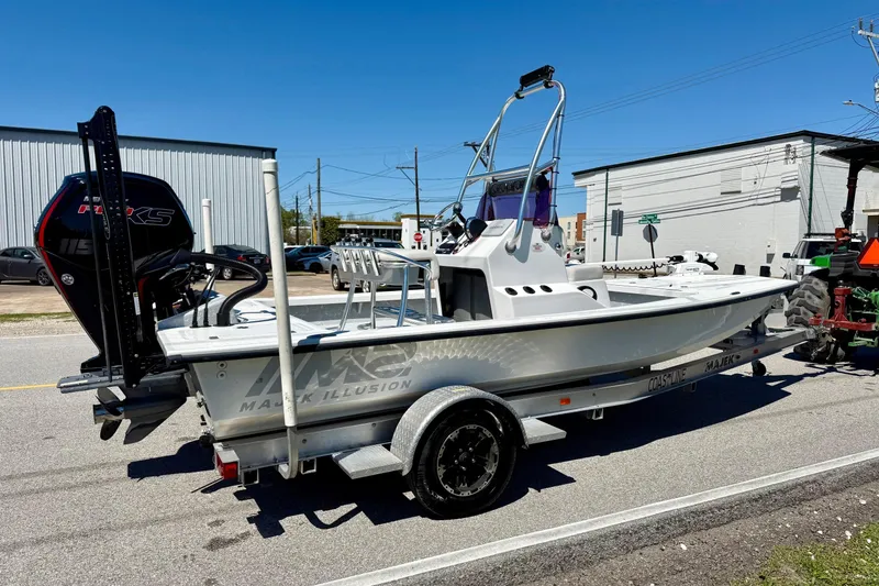 Slide: The Image of 2022 Majek 18 M2 boat on trailer, parked outdoors, with visible outboard motor. - 4