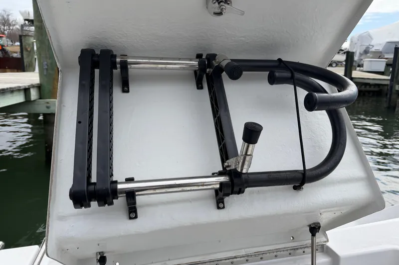 Slide: The Image of 2017 Sportsman Heritage 251 Center Console boat ladder, docked by the water. - 16