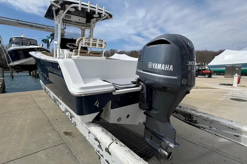 Slide: The Image of 2017 Sportsman Heritage 251 Center Console boat with Yamaha 300 outboard engine on a dock. - 17