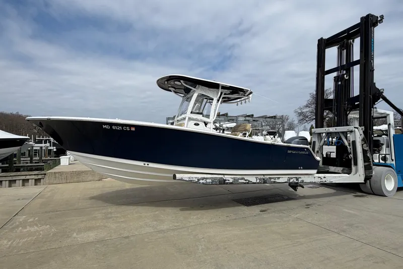Slide: The Image of 2017 Sportsman Heritage 251 Center Console boat on forklift at marina. - 18