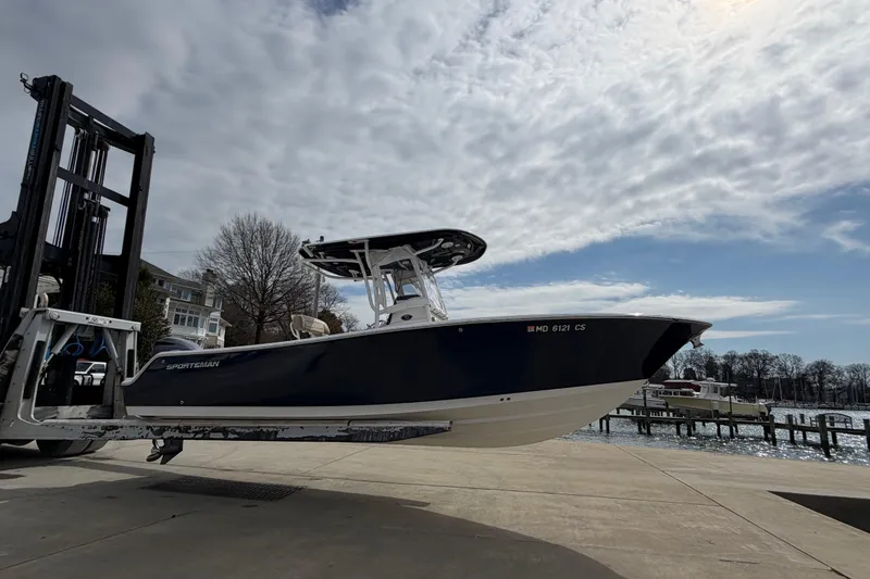 Slide: The Image of 2017 Sportsman Heritage 251 Center Console boat on forklift near waterfront. - 19