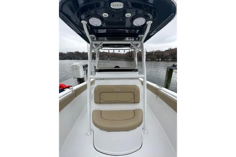 Slide: The Image of 2017 Sportsman Heritage 251 Center Console boat interior with seating and water view. - 2