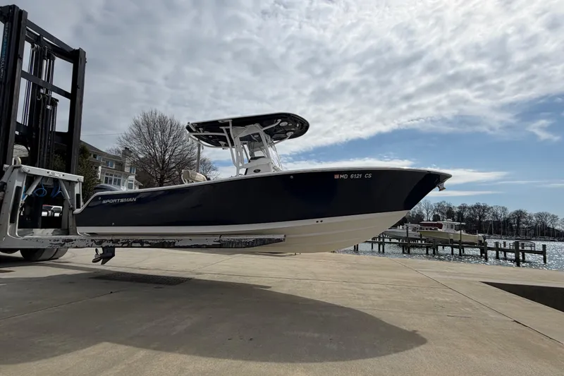 Slide: The Image of 2017 Sportsman Heritage 251 Center Console boat on forklift near waterfront. - 20