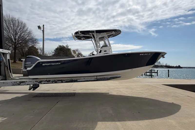 Slide: The Image of 2017 Sportsman Heritage 251 Center Console boat on trailer by waterfront. - 21