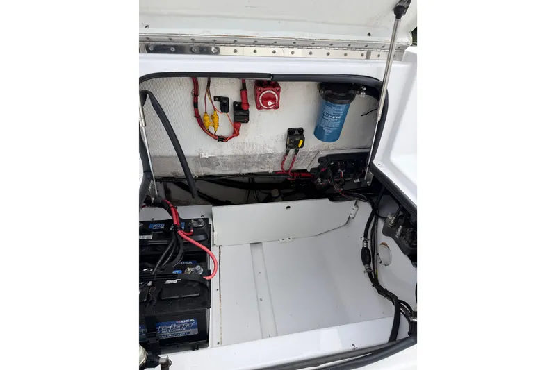 Slide: The Image of 2017 Sportsman Heritage 251 Center Console electrical compartment with wiring and battery setup. - 22