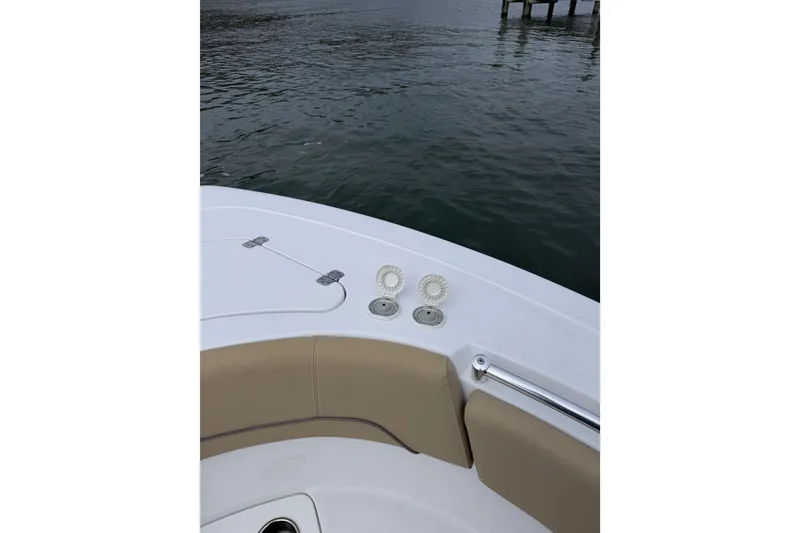 Slide: The Image of 2017 Sportsman Heritage 251 Center Console boat deck with beige seating and ocean view. - 23