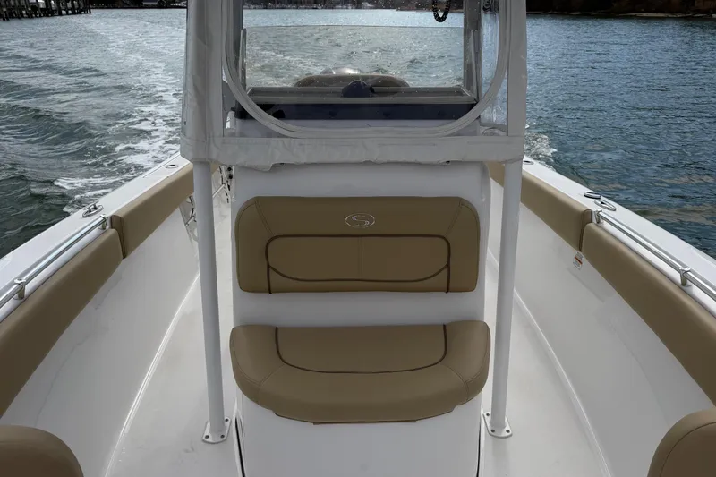 Slide: The Image of 2017 Sportsman Heritage 251 Center Console boat interior with tan seating on the water. - 25