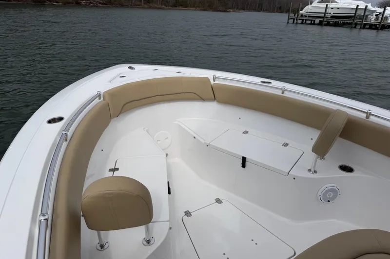 Slide: The Image of 2017 Sportsman Heritage 251 Center Console boat interior with tan seating and storage compartments. - 27