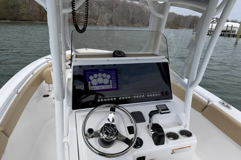 Slide: The Image of 2017 Sportsman Heritage 251 Center Console boat dashboard with steering wheel and navigation display. - 28