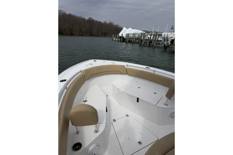 Slide: The Image of 2017 Sportsman Heritage 251 Center Console boat docked by a marina on a cloudy day. - 31