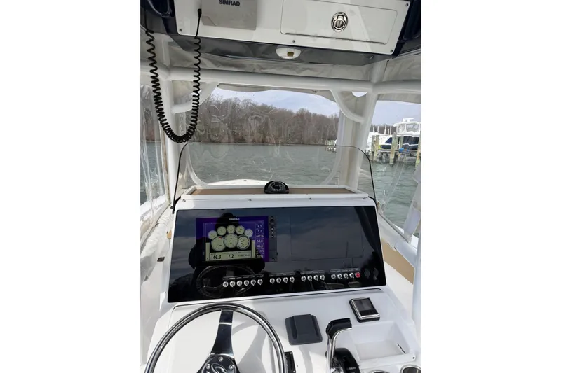 Slide: The Image of 2017 Sportsman Heritage 251 Center Console boat dashboard with navigation display. - 32