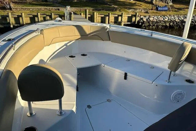 Slide: The Image of 2017 Sportsman Heritage 251 Center Console boat interior with cushioned seating and storage compartments. - 4