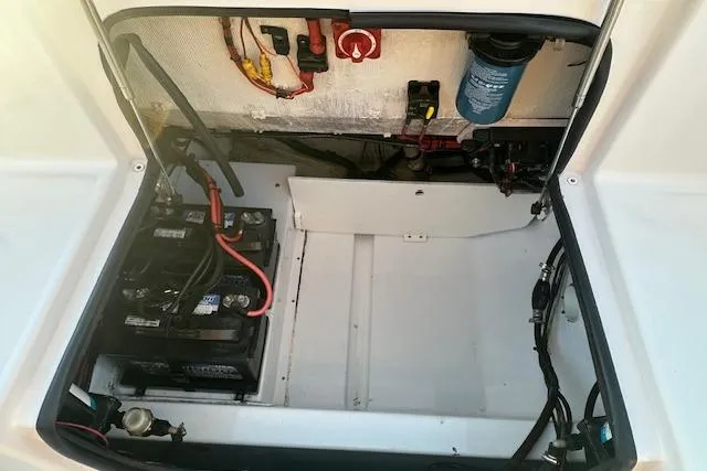 Slide: The Image of 2017 Sportsman Heritage 251 Center Console battery compartment with wiring and components. - 7