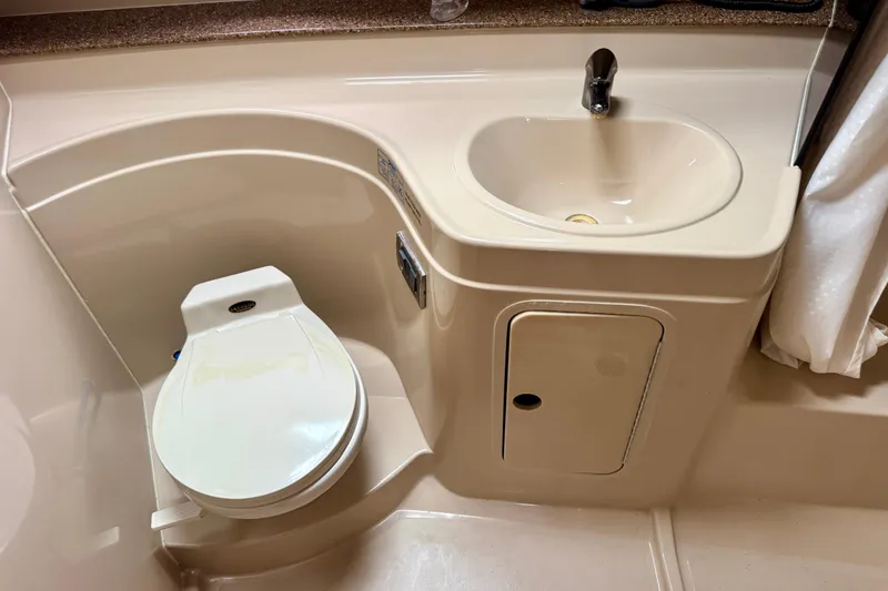 Slide: The Image of 2001 Cruisers Yachts 3470 Express bathroom with toilet and sink. - 11
