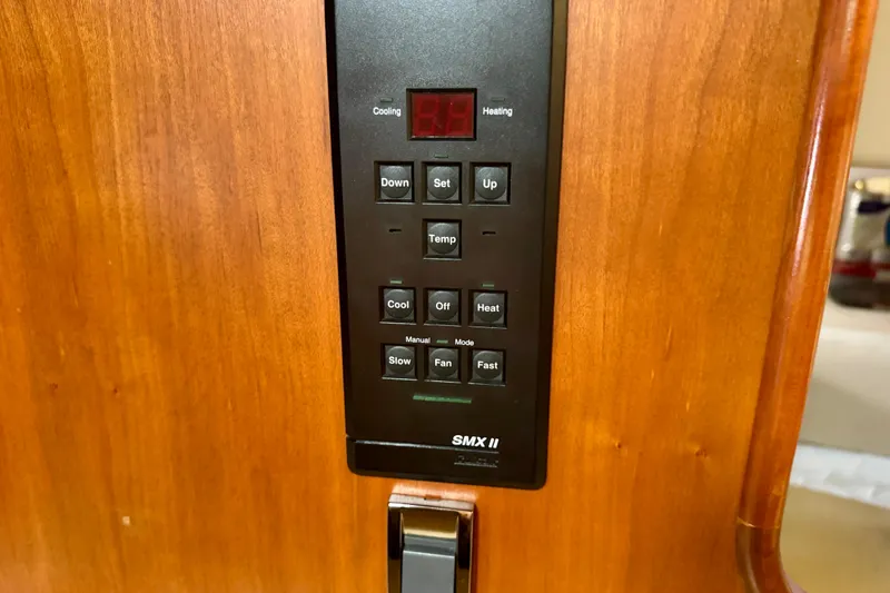 Slide: The Image of Control panel of a 2001 Cruisers Yachts 3470 Express, featuring temperature and fan settings. - 16