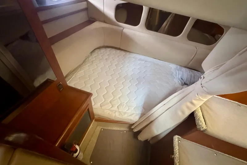 Slide: The Image of 2001 Cruisers Yachts 3470 Express cabin interior with bed and wooden furnishings. - 21