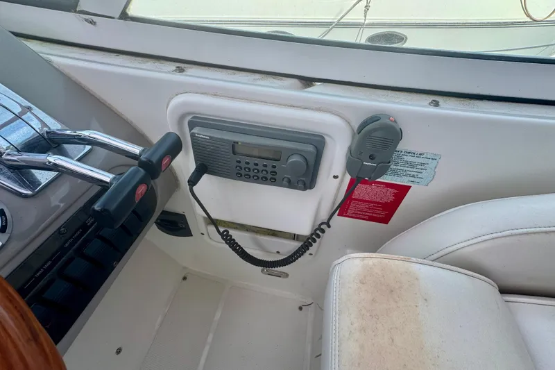 Slide: The Image of 2001 Cruisers Yachts 3470 Express helm with radio and controls. - 27