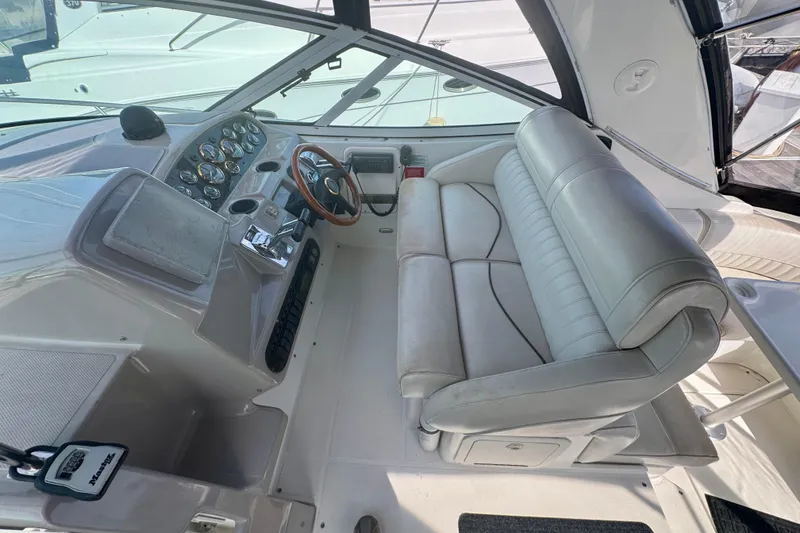 Slide: The Image of 2001 Cruisers Yachts 3470 Express cockpit with leather seating and control panel. - 28