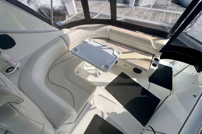 Slide: The Image of 2001 Cruisers Yachts 3470 Express interior with curved seating and table. - 29