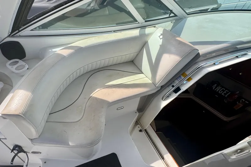 Slide: The Image of 2001 Cruisers Yachts 3470 Express interior seating area with white upholstery. - 30
