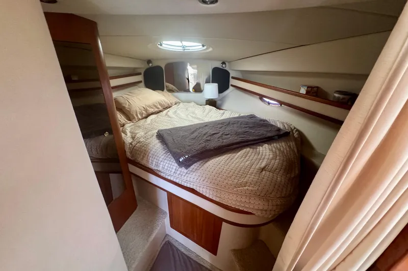 Slide: The Image of Cozy cabin interior of 2001 Cruisers Yachts 3470 Express with bed and porthole. - 6