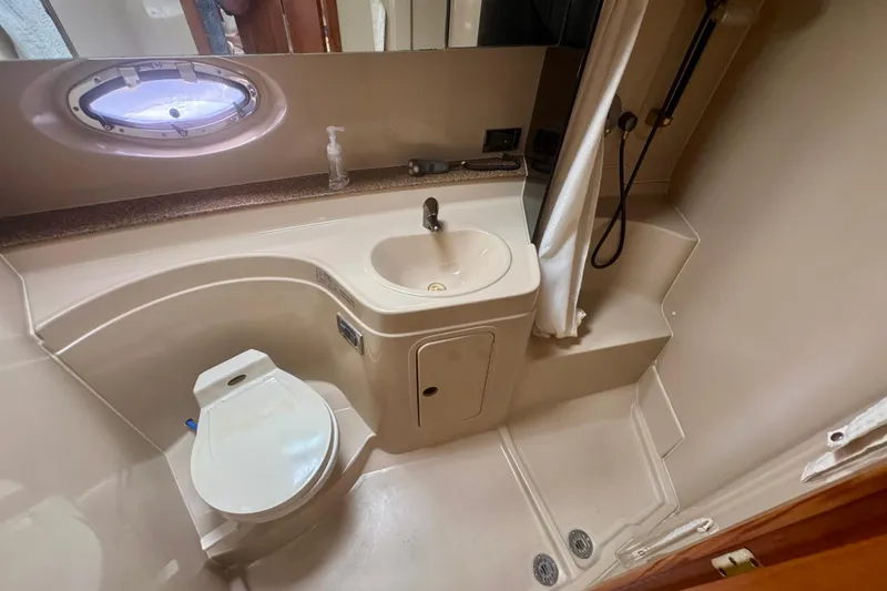 Slide: The Image of 2001 Cruisers Yachts 3470 Express bathroom with sink, toilet, and shower. - 9
