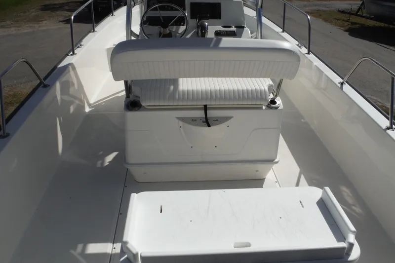 Slide: The Image of 2015 Boston Whaler 210 Montauk boat interior with seating and steering console. - 10