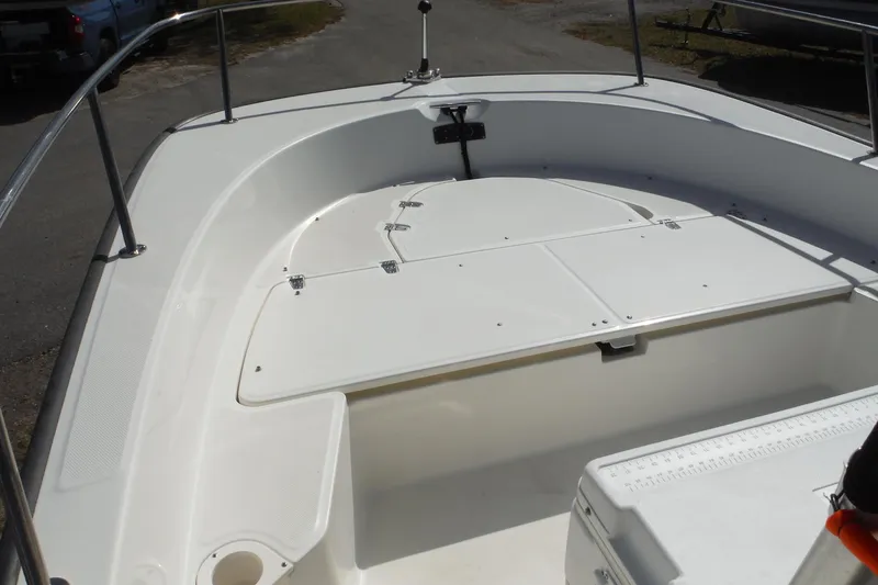 Slide: The Image of 2015 Boston Whaler 210 Montauk boat interior with storage compartments and railing. - 12