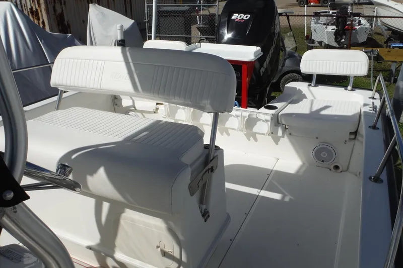 Slide: The Image of 2015 Boston Whaler 210 Montauk boat interior with seating and Mercury outboard motor. - 13