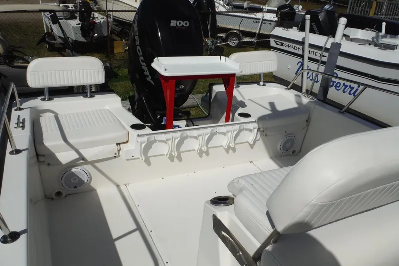 Slide: The Image of 2015 Boston Whaler 210 Montauk boat interior with seating and Mercury engine. - 15