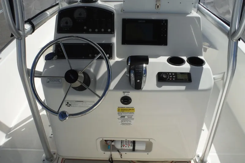 Slide: The Image of 2015 Boston Whaler 210 Montauk boat console with steering wheel and controls. - 16