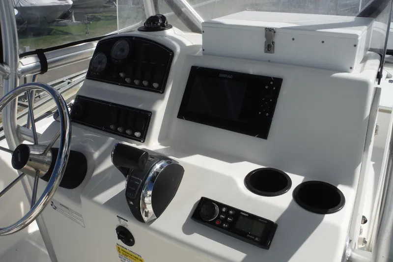 Slide: The Image of Control panel of a 2015 Boston Whaler 210 Montauk boat with steering wheel and electronics. - 18