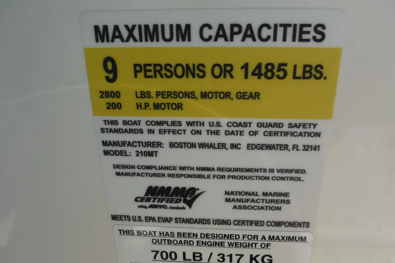 Slide: The Image of 2015 Boston Whaler 210 Montauk capacity label, 9 persons or 1485 lbs, 200 HP motor. - 21