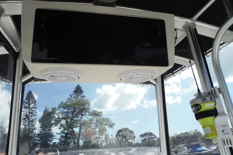 Slide: The Image of 2015 Boston Whaler 210 Montauk interior with speakers and clear sky view. - 22