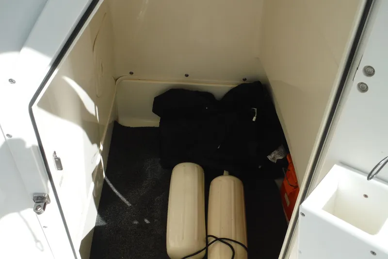 Slide: The Image of Interior storage compartment of a 2015 Boston Whaler 210 Montauk boat with fenders. - 28