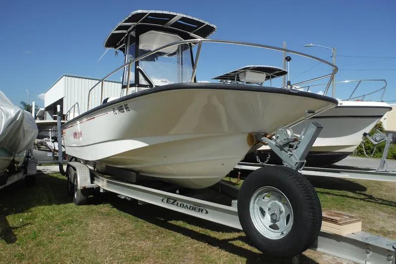 Slide: The Image of 2015 Boston Whaler 210 Montauk boat on trailer, parked outdoors. - 3