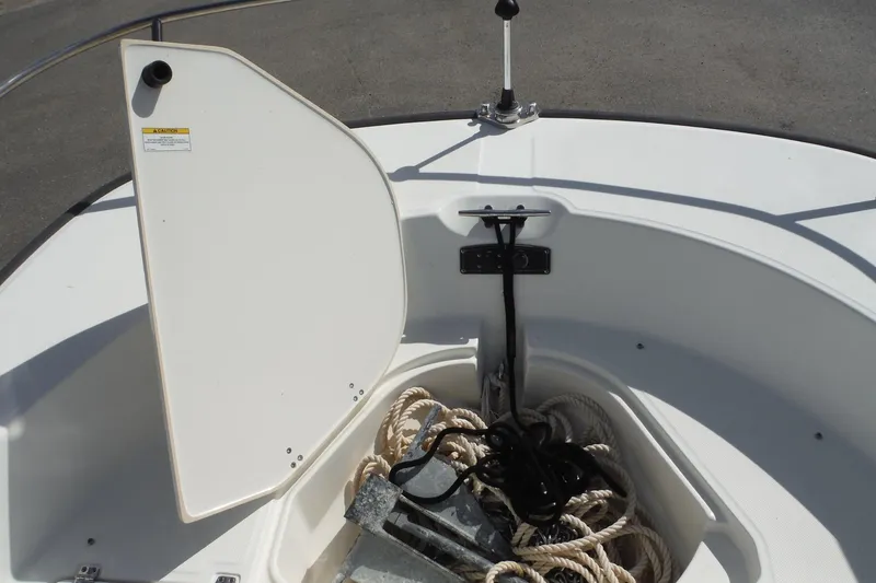 Slide: The Image of Open anchor storage on 2015 Boston Whaler 210 Montauk with ropes and anchor visible. - 30