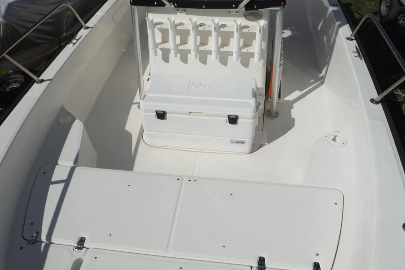 Slide: The Image of 2015 Boston Whaler 210 Montauk boat interior with cooler and rod holders. - 32