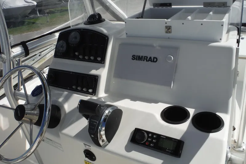 Slide: The Image of 2015 Boston Whaler 210 Montauk boat dashboard with Simrad electronics and steering wheel. - 34