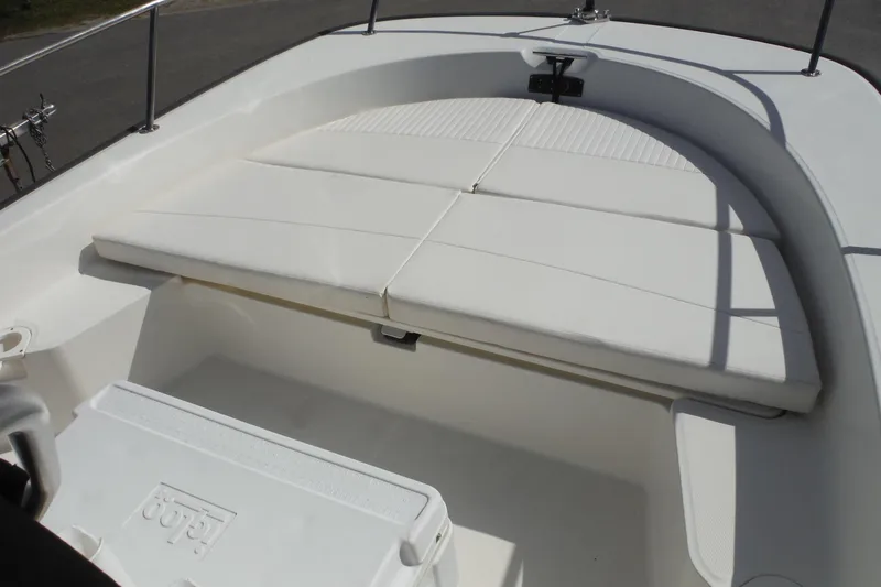 Slide: The Image of 2015 Boston Whaler 210 Montauk boat interior with cushioned seating and cooler. - 35