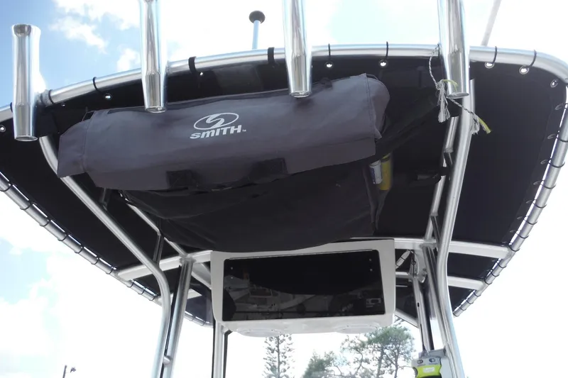 Slide: The Image of 2015 Boston Whaler 210 Montauk T-top with rod holders and storage bag. - 38