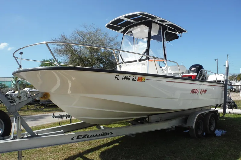 Slide: The Image of 2015 Boston Whaler 210 Montauk boat on trailer under clear blue sky. - 4