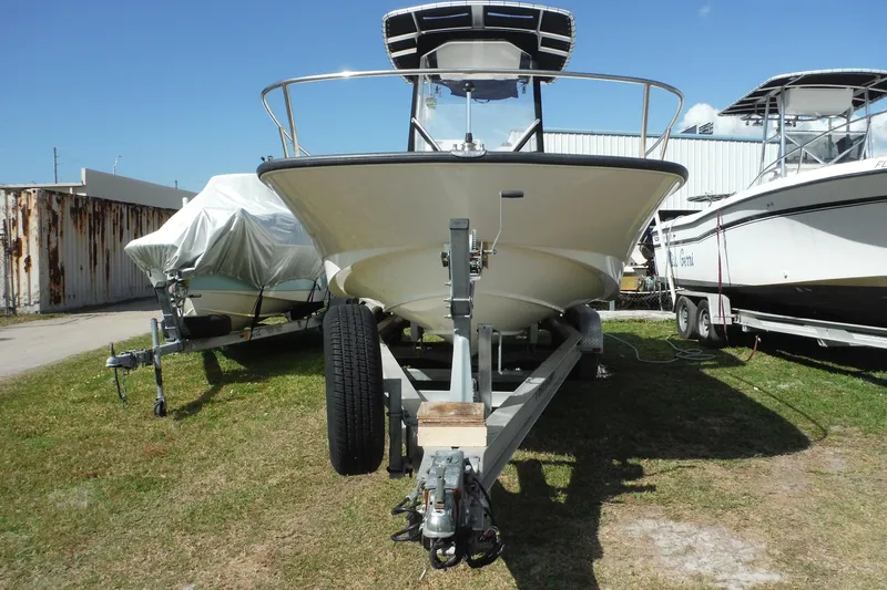 Slide: The Image of 2015 Boston Whaler 210 Montauk boat on trailer, parked outdoors under clear sky. - 5
