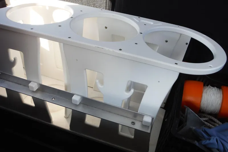 Slide: The Image of White rod holder on a 2015 Boston Whaler 210 Montauk boat, with orange buoy and rope nearby. - 52