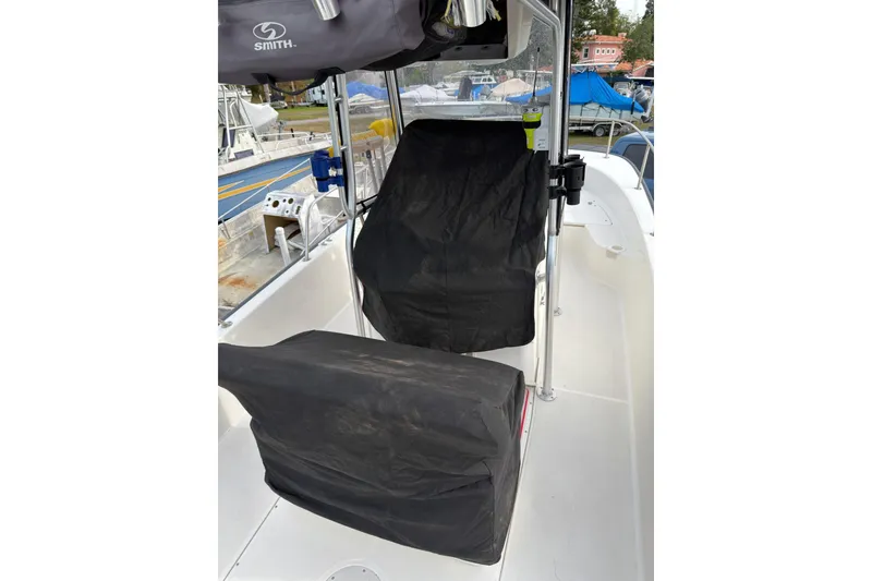 Slide: The Image of 2015 Boston Whaler 210 Montauk interior with covered seats and equipment. - 53