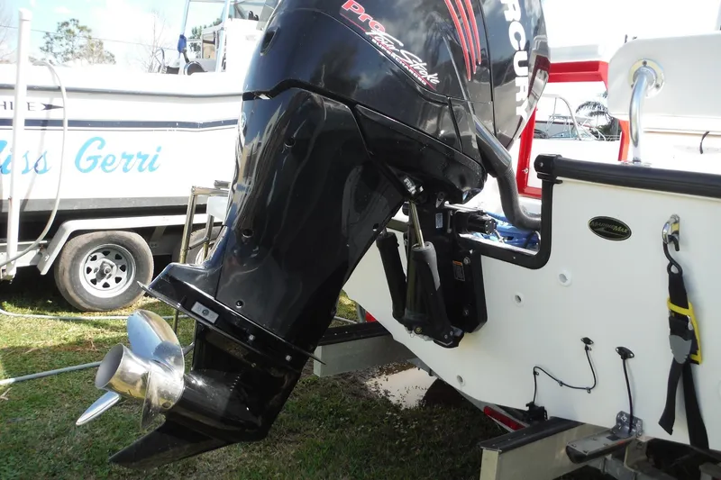 Slide: The Image of 2015 Boston Whaler 210 Montauk with Mercury outboard motor, parked on grass. - 8