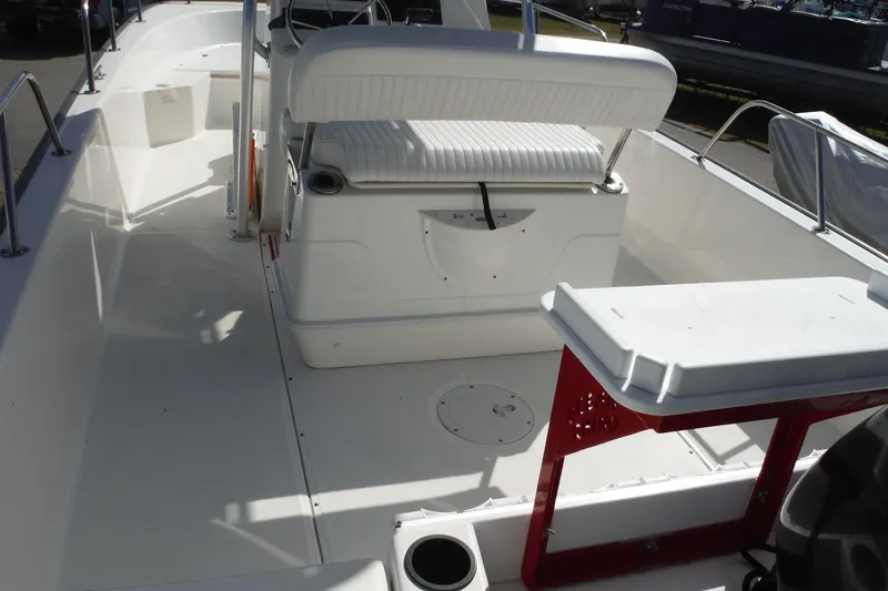 Slide: The Image of 2015 Boston Whaler 210 Montauk boat interior with seating and console. - 9